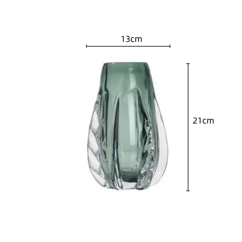 A sleek translucent sage green decorbites crystal vase with leaf-inspired design and clear cut facets for living room decor