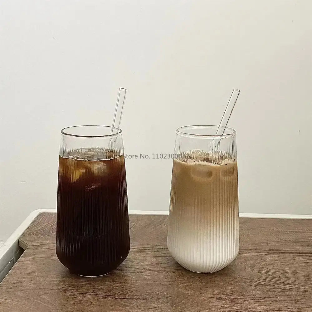 Two tall clear glass cups with vertical ridged texture and matching transparent straws from decorbites clear glass set