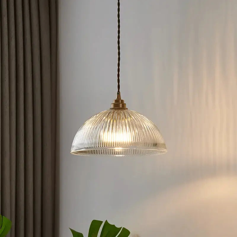 Clear ribbed glass chandelier pendant lights with brass finish and twisted dark cord for bedroom pendant lights