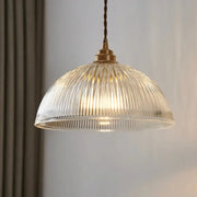 A warm-toned ribbed glass chandelier pendant light with brass finish and twisted cord for bedroom pendant lights