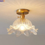 A clear ribbed glass copper led ceiling light with fluted petal design and gold-toned copper led ceiling hardware