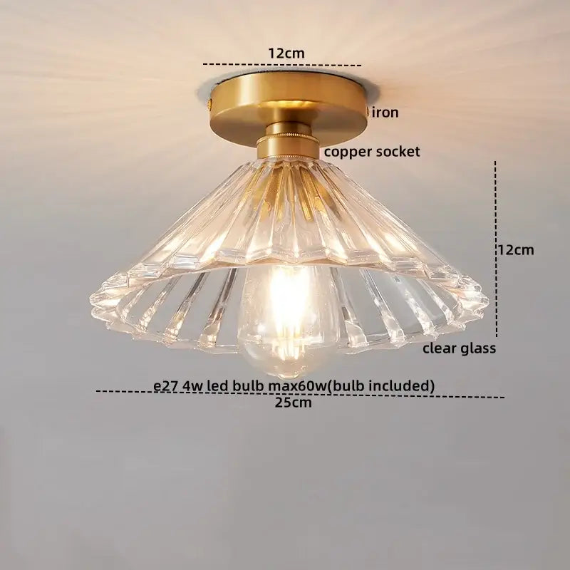 A clear glass copper led ceiling light with fluted design, brass iron base, and copper socket for dining room