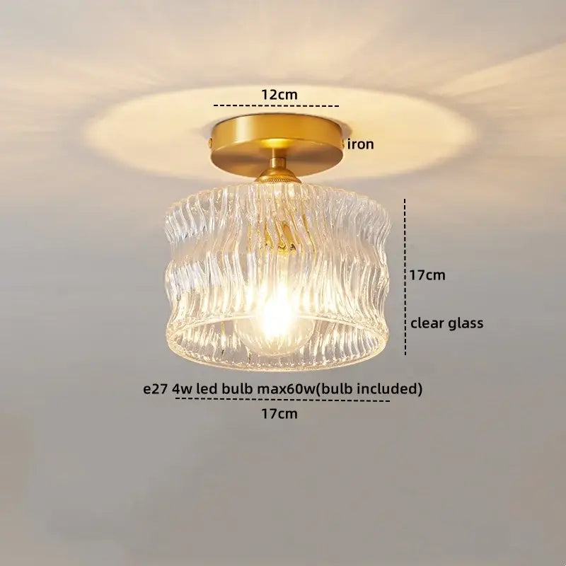 A ribbed glass pendant ceiling light with a brass iron base and e27 copper led bulb for dining room use