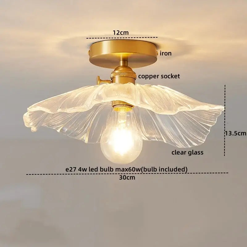 A ribbed clear glass copper led ceiling light with a fluted shade on an antique brass iron base for dining room chandelier