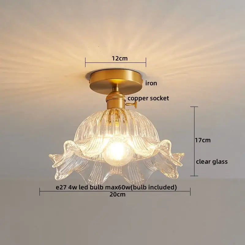 A delicate clear ribbed glass copper led ceiling light with petal design on iron and copper socket assembly
