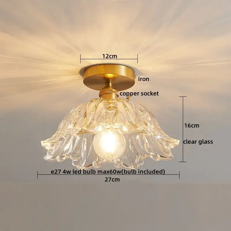 A delicate clear glass copper led ceiling light with a brass iron base and copper socket for dining rooms