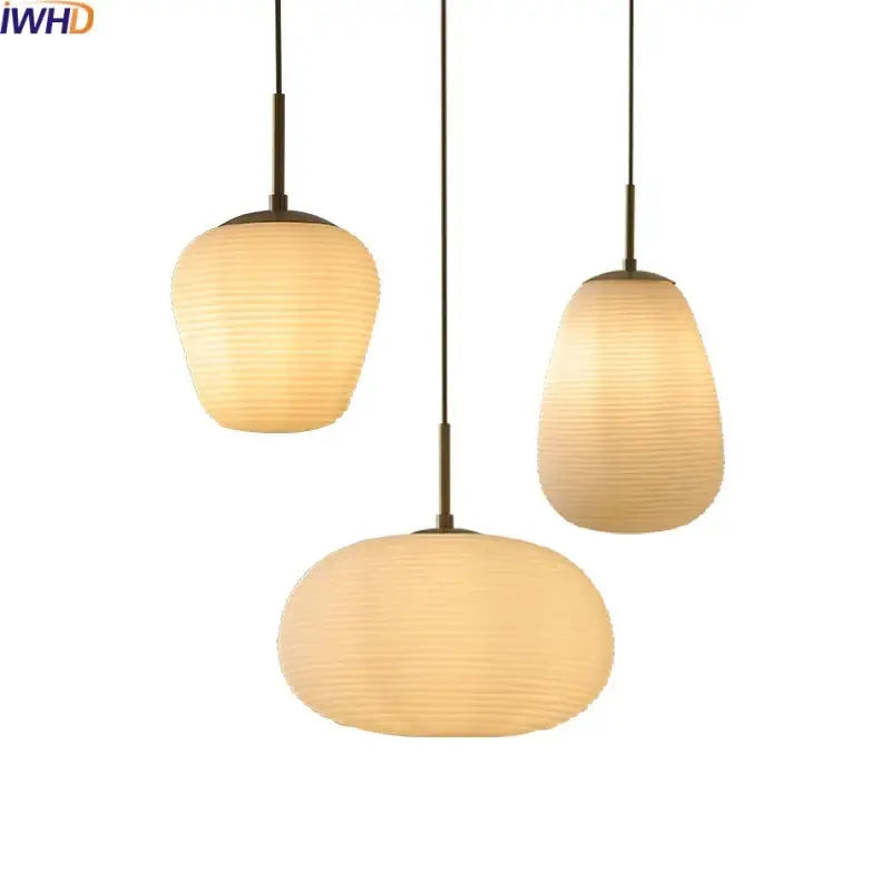 Three warm-toned ribbed glass copper led pendant chandelier lights hanging from slender rods for dining room use