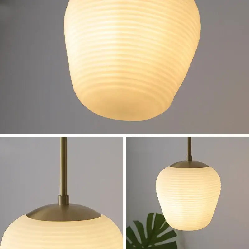 Warm softly glowing off-white ribbed glass copper led pendant chandelier with matte brass fixture for dining room lighting