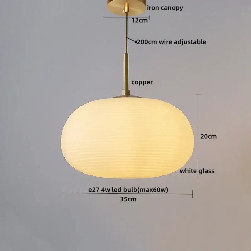 A warm glowing ribbed glass copper led pendant chandelier with white shade and copper led pendant hardware for dining room