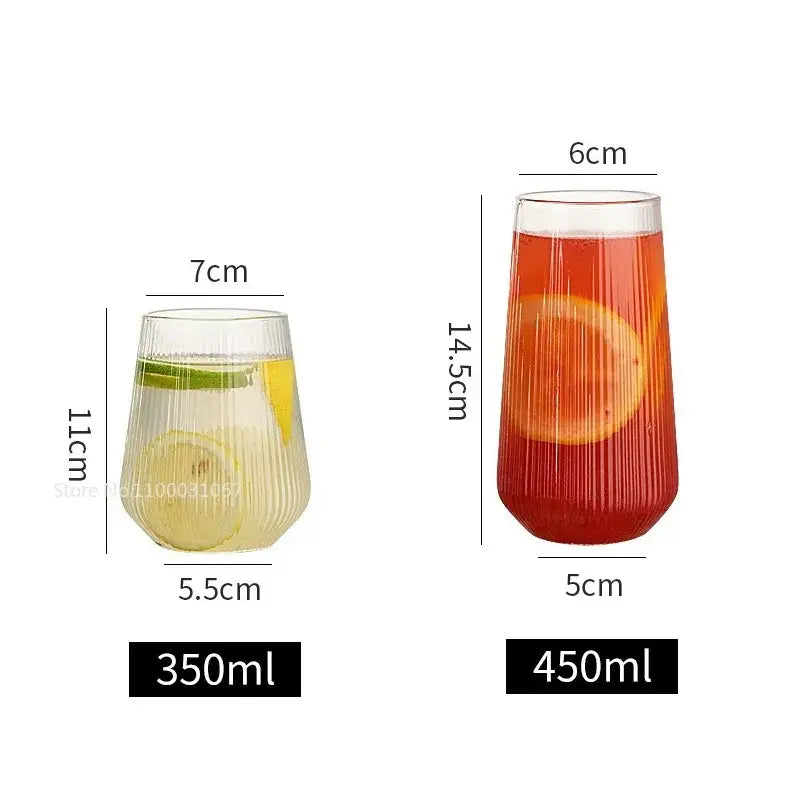 Two clear ribbed glass cups of different sizes from a glass cup set with bamboo lid and straw for kitchen dining