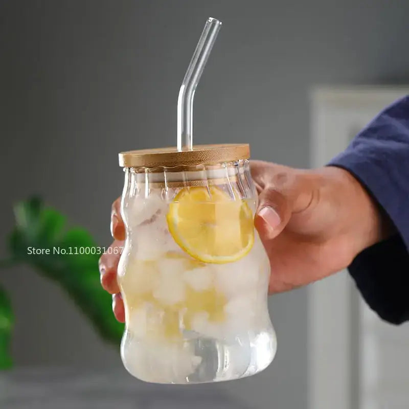 Clear glass cup from decorbites glass cup set with ribbed design bamboo lid and curved straw filled with ice and lemon slices