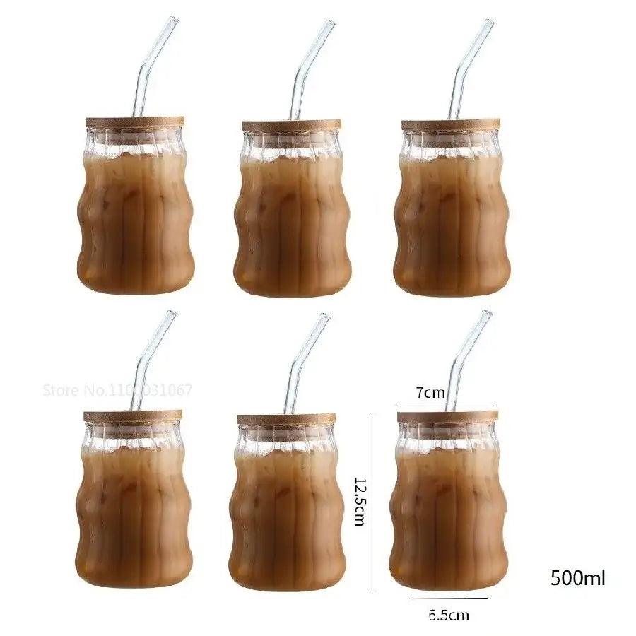Ribbed glass cup set with clear tumblers featuring bamboo-patterned ridges wooden lids and clear curved straws for dining room