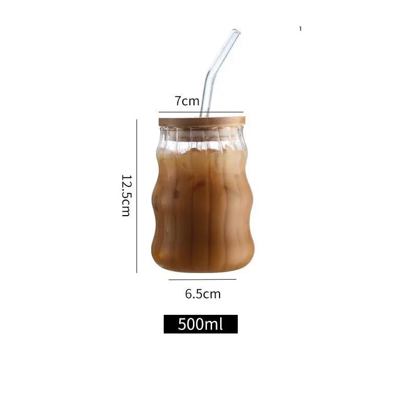 A ribbed glass cup set by decorbites featuring clear glass cups with bamboo lids and curved straws for dining room use