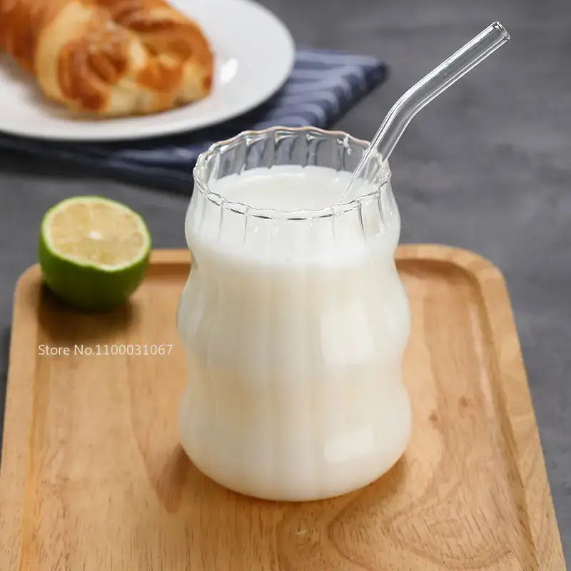 Clear glass cup filled with white liquid featuring a fluted rim and ribbed body in decorbites glass cup set