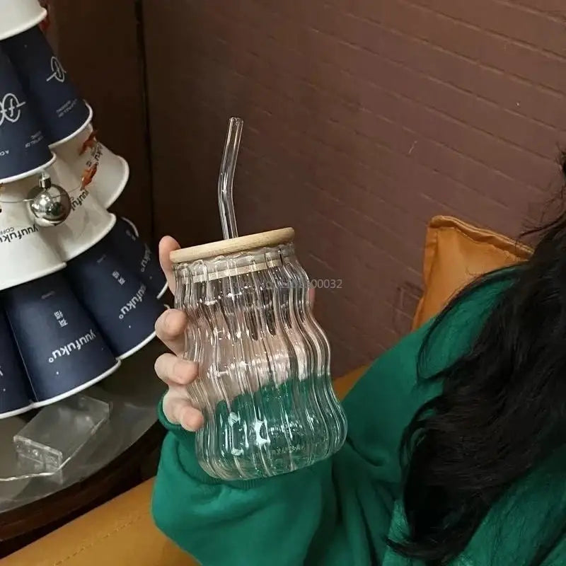 Clear glass cup with ribbed texture, bamboo lid, and clear lip straw by decorbites glass for kitchen use