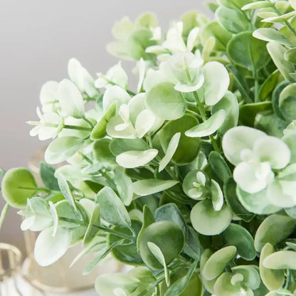 A ribbed glass eucalyptus leaves vase with lush artificial eucalyptus leaves in green and pale cream for lavender decor