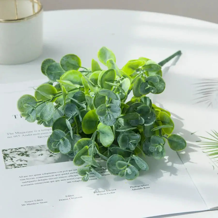 A ribbed glass eucalyptus leaves vase holding a lush artificial green eucalyptus bouquet for lavender living room decor