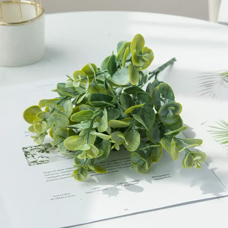 A ribbed glass eucalyptus leaves vase with lush artificial eucalyptus leaves in varying green shades for lavender decor