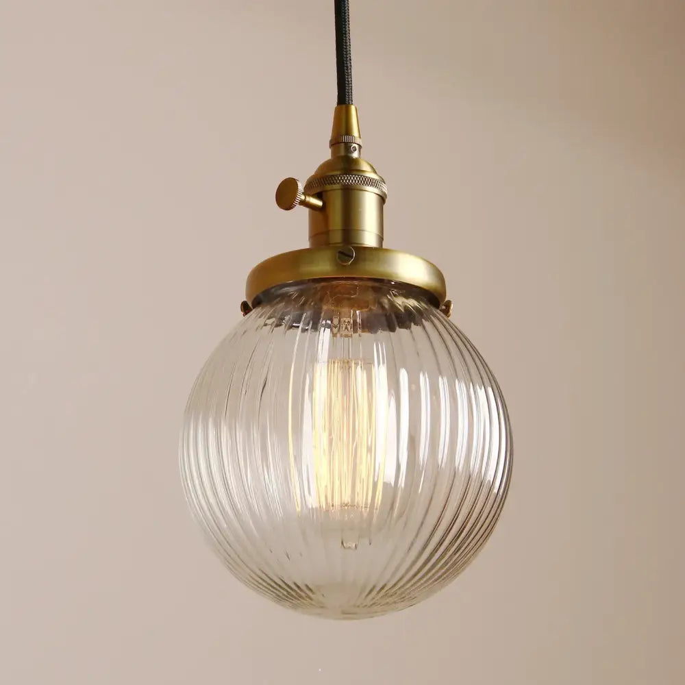 Vintage-style pendant light with clear ribbed glass globe and brass fixture for living room decorbites clear glass globe