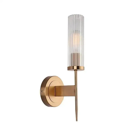 A sleek brass decorbites gold led wall light with a ribbed glass shade and slender stem for bedroom decor