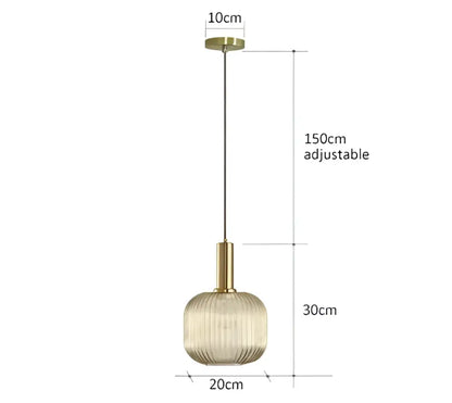 A modern ribbed glass pendant light with a gold-toned metal fixture and textured amber shade for dining rooms