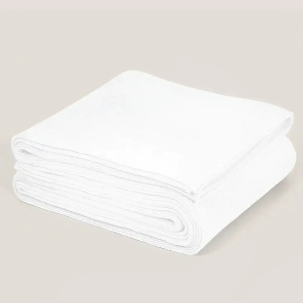 A neatly folded white linen blanket with subtle texture shown alongside a ribbed gray organic cotton weighted blanket for sleep