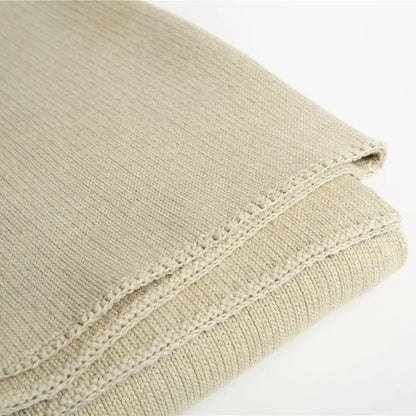 Beige ribbed organic cotton weighted blanket with textured woven pattern and neatly stitched edges for bedroom sleep
