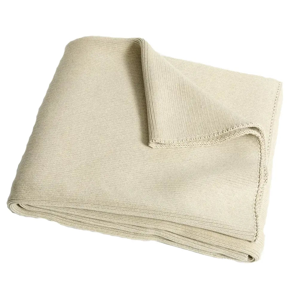 Beige knitted throw blanket with soft textured weave and stitched edges paired with ribbed gray organic cotton weighted blanket