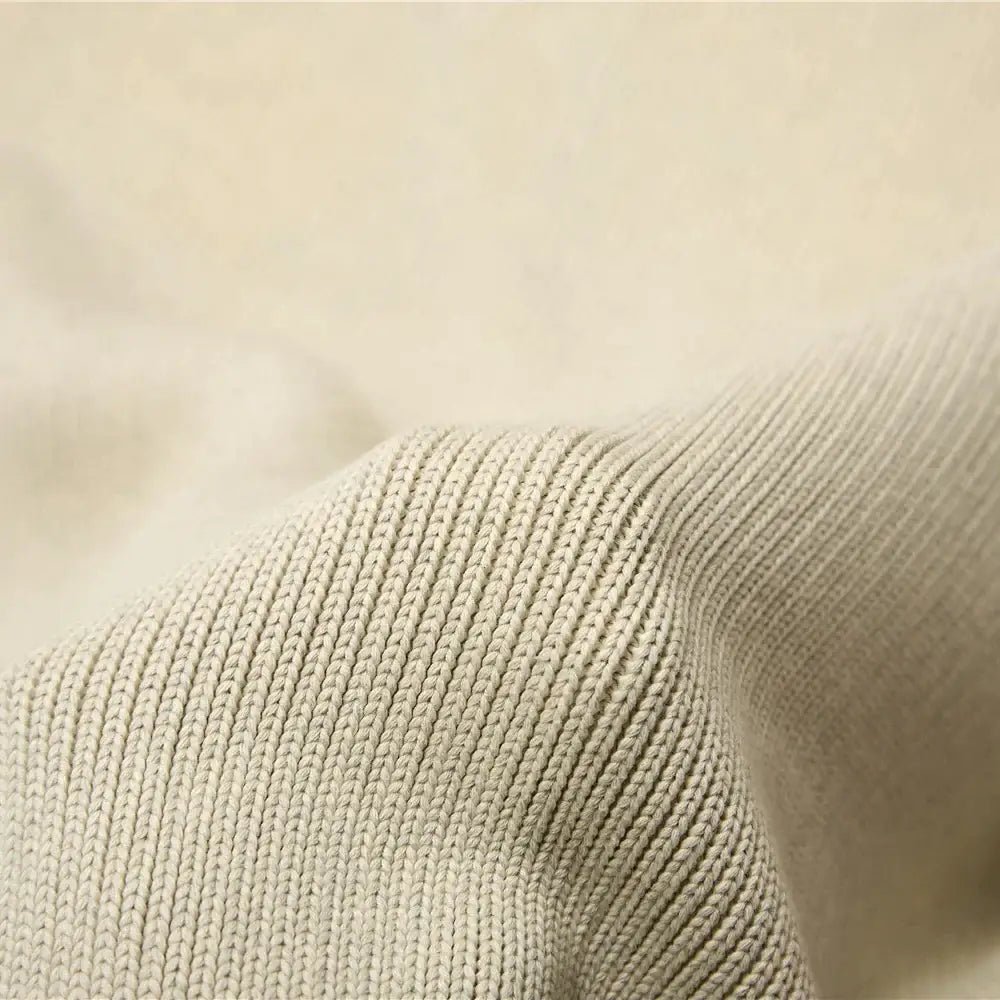 Beige ribbed knit fabric of an organic cotton weighted blanket with a soft textured weave for bedroom sleep use