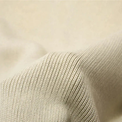 Beige ribbed knit fabric of an organic cotton weighted blanket with a soft textured weave for bedroom sleep use