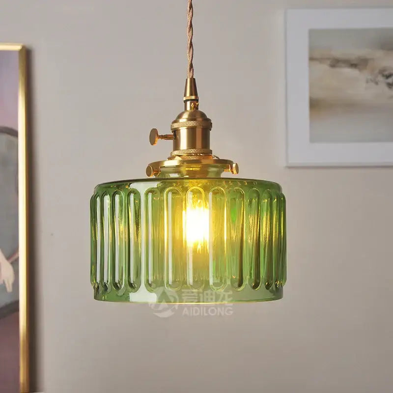 Ribbed green glass pendant light with brass hardware featuring a ribbed glass pendant light design for bedroom use