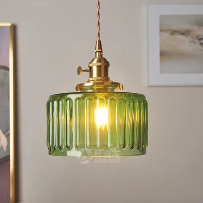Green ribbed glass pendant light with brass hardware ideal as a stylish glass pendant light for bedroom use