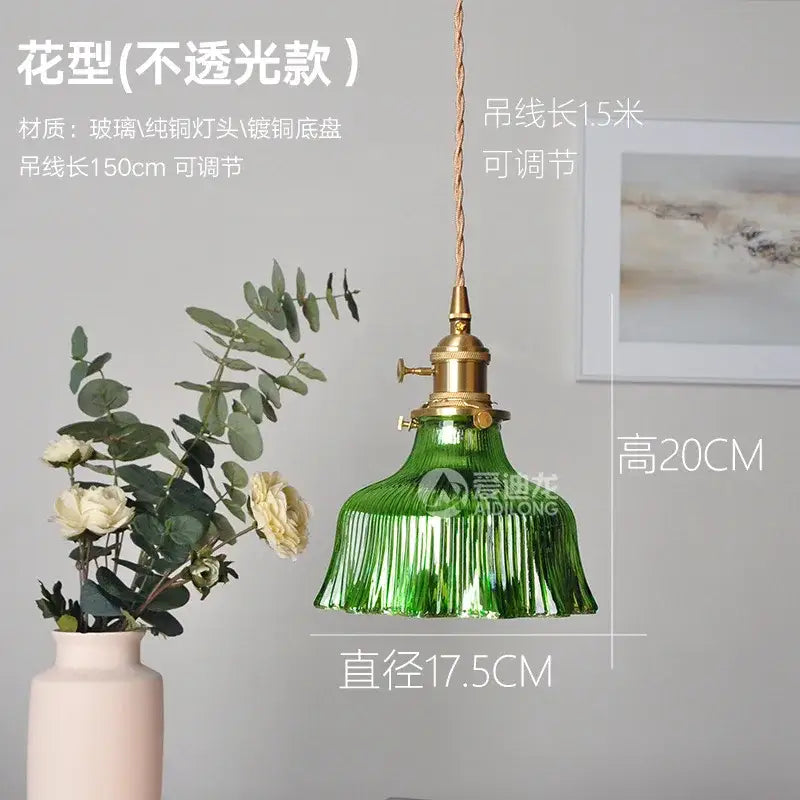 Green ribbed glass pendant light with brass hardware and adjustable cord ideal for bedroom lighting