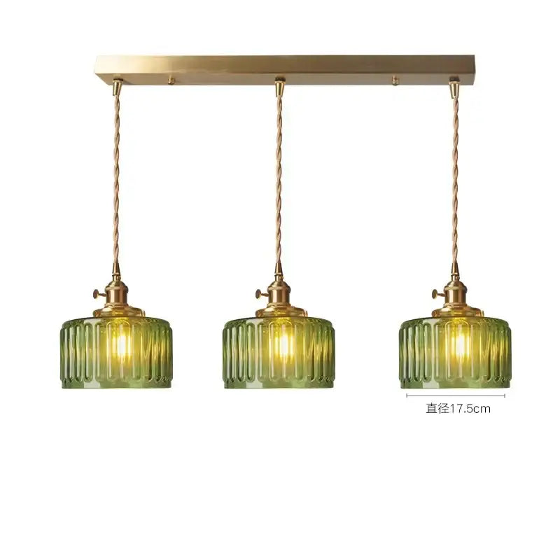Set of three green glass pendant lights with ribbed design brass hardware ideal for bedroom lighting