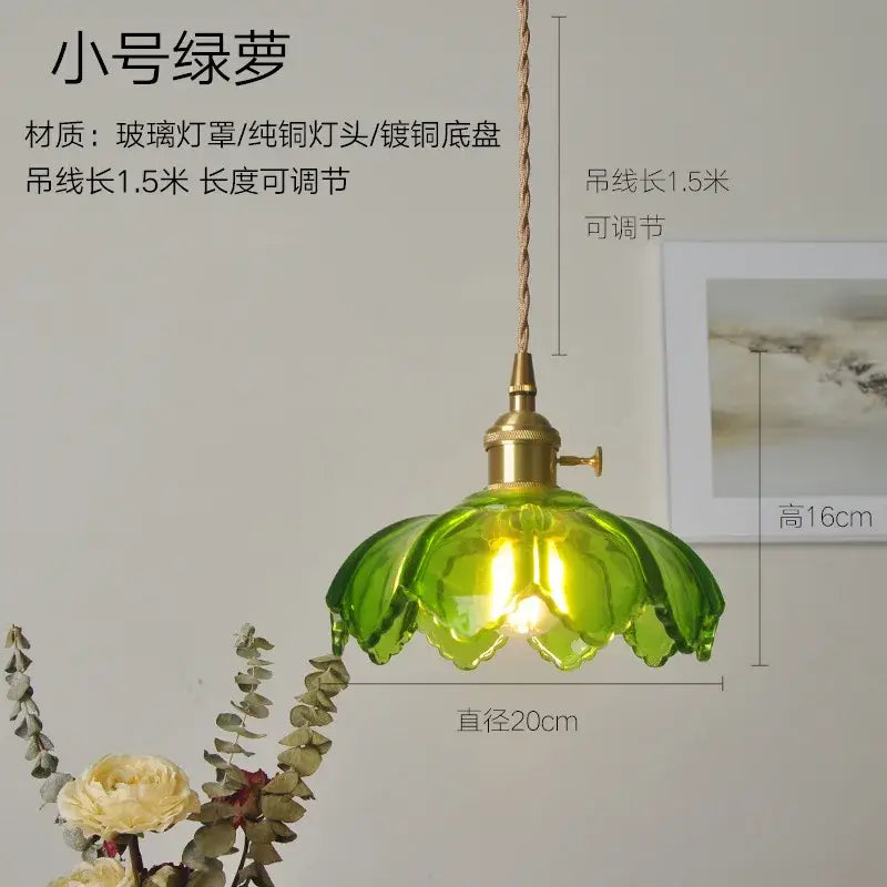 Ribbed green glass pendant light with petal shape brass hardware and twisted cord for bedroom lighting