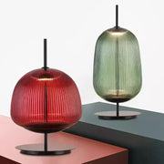 Red and green ribbed glass table lamp with black metal base ideal for bedroom lighting and decorbites green red style