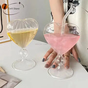 Clear heart-shaped glass mugs with ribbed detailing and bulbous stem filled with yellow and pink drinks decorbites heart love