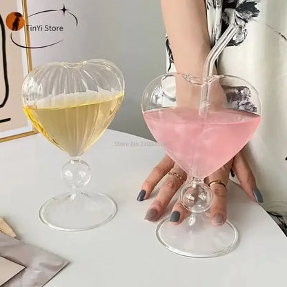 Clear heart-shaped glass mugs with ribbed detailing and bulbous stem filled with yellow and pink drinks decorbites heart love