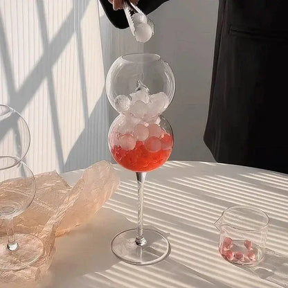 A clear double-globed glass mug with ribbed heart love design filled with ice and red liquid from decorbites glass mugs