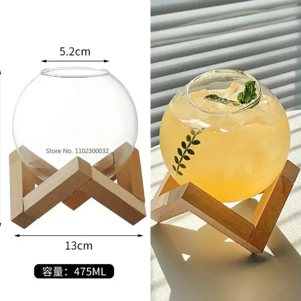 Clear spherical glass mug with ribbed heart design on wooden stand holding 475ml yellow beverage garnished with mint decorbites heart love