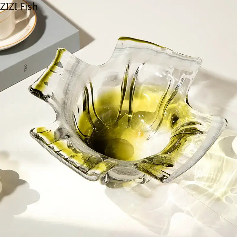 A translucent glass ashtray with leaf design and green and yellow accents paired with a green glass vase hydroponics set