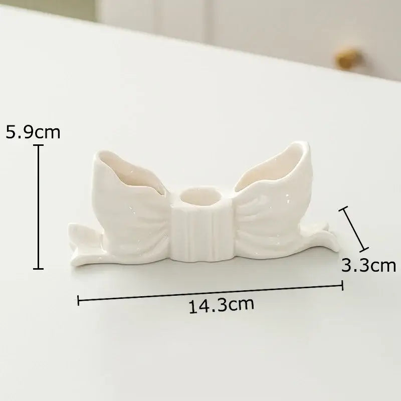 White ceramic bowknot candle holder with glossy finish and three openings for decorbites bowknot candle decor