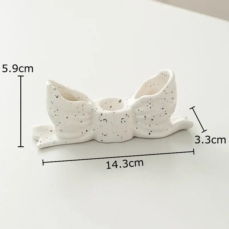 White speckled ceramic bowknot candle holder by decorbites for elegant bedroom desk decor and candle display