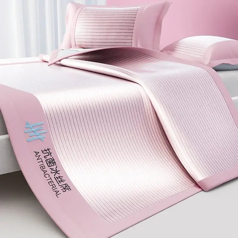 Pink antibacterial cooling bed mat set with ribbed texture and soft satin-like finish for bedroom use