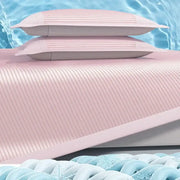 Pink ribbed soft bed mat set with matching pillowcases featuring textured fabric and subtle vertical pleats