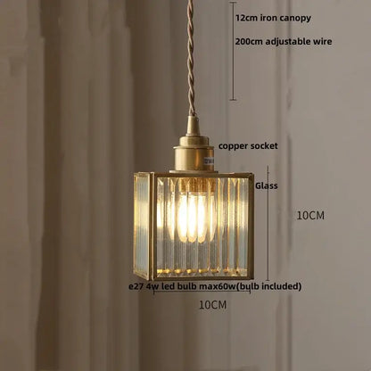 A brass-framed rectangular pendant light with ribbed teal blue glass panels and a copper socket for dining room decorbites blue glass led lighting