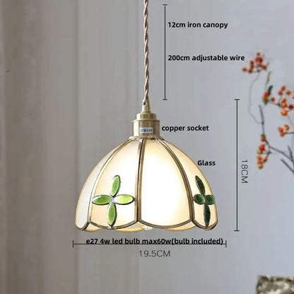 A delicate cream pendant light with green clover motifs and brass copper socket complementing decorbites blue glass led designs