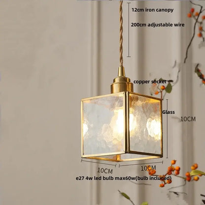 A square brass-framed pendant light with ribbed teal blue glass led panels and a copper socket for dining room decorbites blue glass