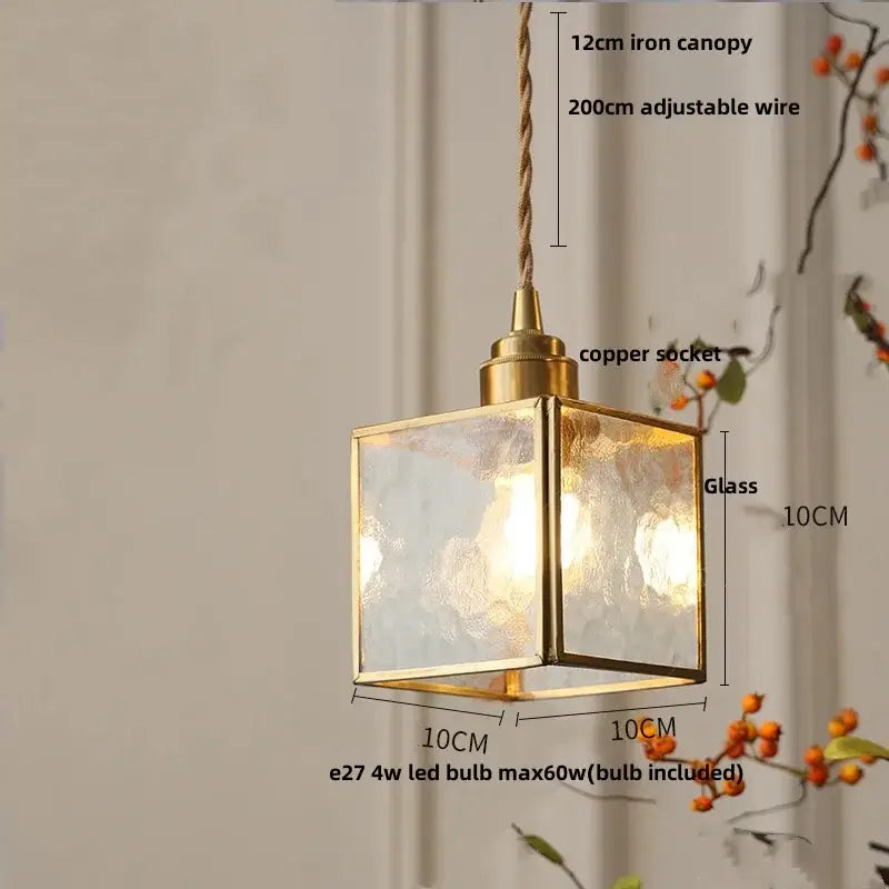 A square brass-framed pendant light with ribbed teal blue glass led panels and a copper socket for dining room decorbites blue glass