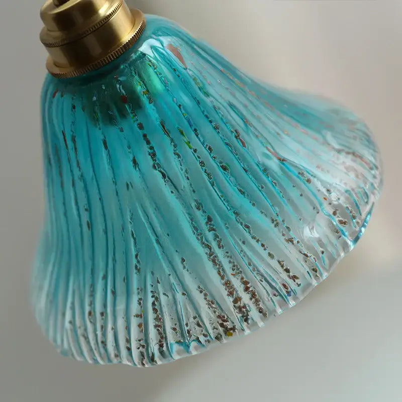 Ribbed teal blue glass led pendant light with vertical ridges and gold flecks featuring a brass fixture for dining room decorbites blue glass